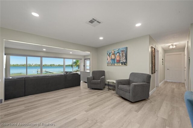 1622 Dinner Dr, Sebring, FL 33870 - living area featuring visible vents, recessed lighting, light wood-type flooring, and a water view