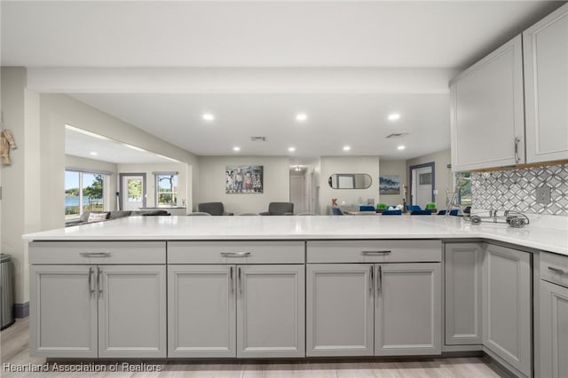 1622 Dinner Dr, Sebring, FL 33870 - kitchen with gray cabinets, open floor plan, recessed lighting, a peninsula, and light countertops