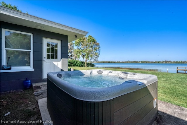1622 Dinner Dr, Sebring, FL 33870 - view of swimming pool with a lawn, a water view, and a hot tub