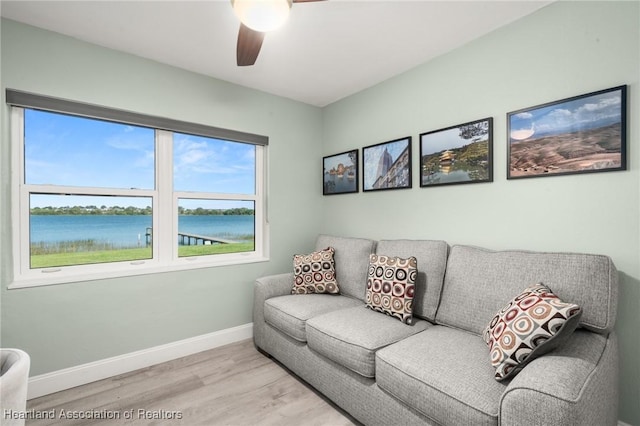 1622 Dinner Dr, Sebring, FL 33870 - living area with light wood-style floors, baseboards, a water view, and ceiling fan