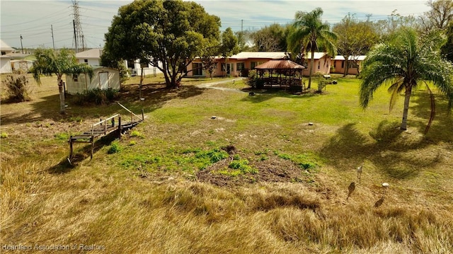 view of yard with a gazebo and a shed