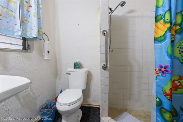 bathroom with toilet and walk in shower