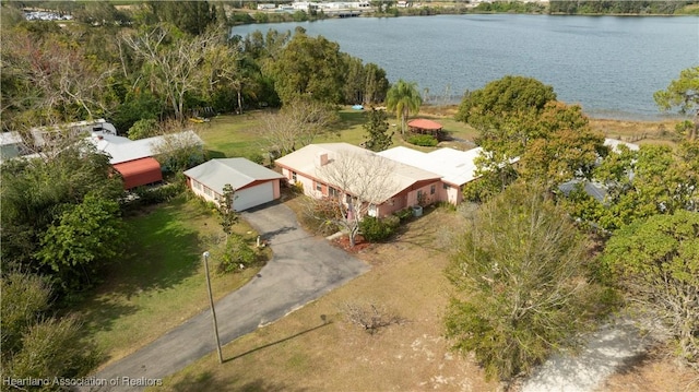 birds eye view of property with a water view