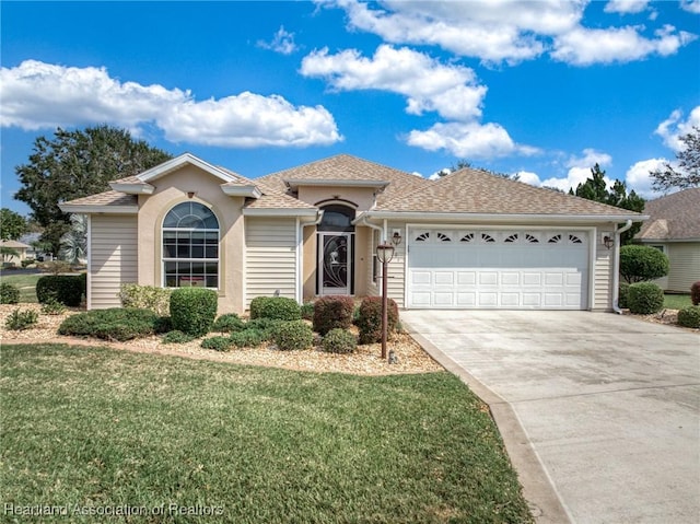 view of front of property with a garage and a front lawn