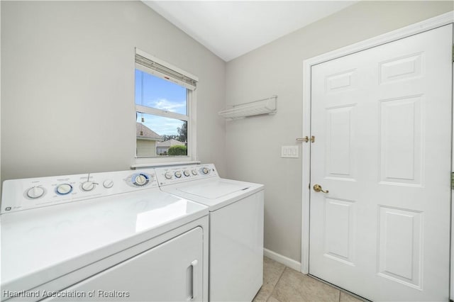 laundry area with light tile patterned floors and separate washer and dryer