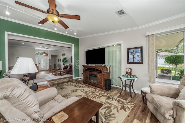 living room with crown molding and hardwood / wood-style floors