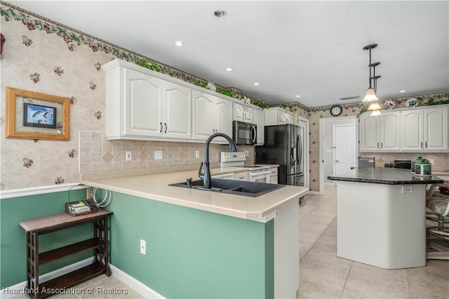 kitchen with white cabinets, pendant lighting, a kitchen bar, and kitchen peninsula