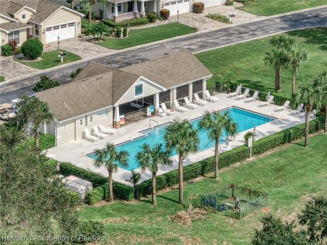 view of swimming pool featuring a yard and a patio