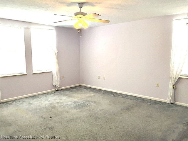 spare room featuring carpet flooring, a ceiling fan, and baseboards