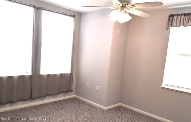 unfurnished room with carpet flooring, ceiling fan, and baseboards