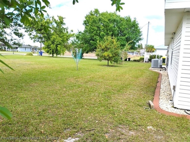 view of yard with central air condition unit