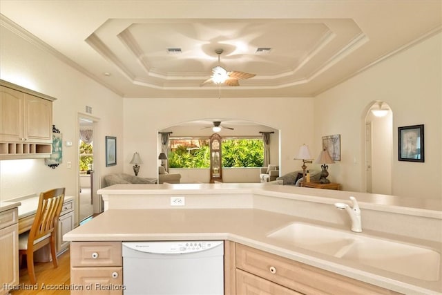 kitchen featuring a tray ceiling, open floor plan, and dishwasher