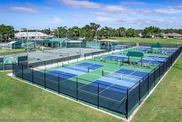 view of sport court featuring a lawn and fence