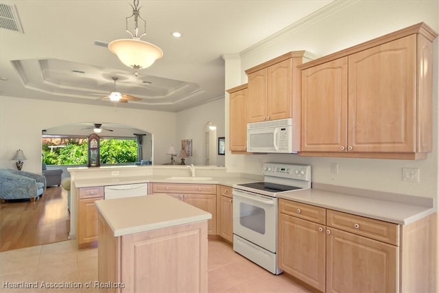 kitchen featuring light brown cabinetry, white appliances, a raised ceiling, and visible vents