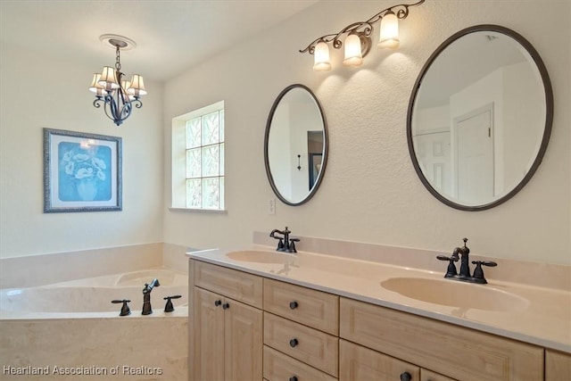 bathroom with a chandelier, a garden tub, a sink, and double vanity