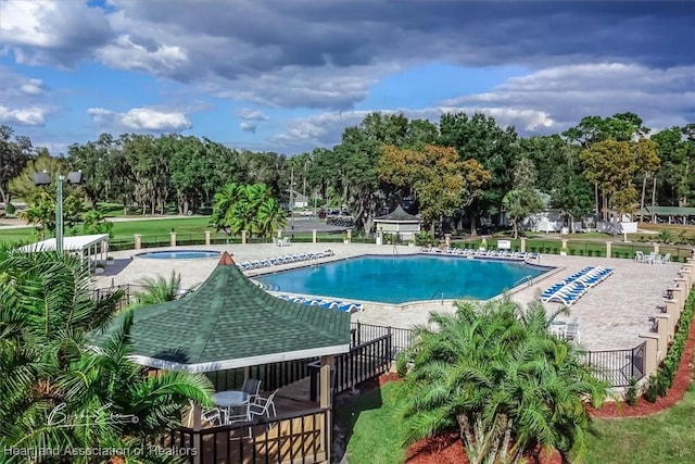 pool featuring a patio and a hot tub