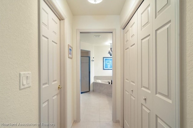 hallway featuring light tile patterned floors