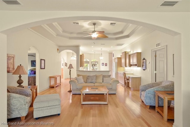 living room with a raised ceiling and visible vents