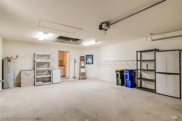 garage featuring a garage door opener and electric water heater