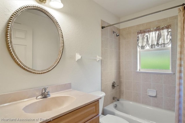 bathroom featuring toilet, shower / tub combo, a textured wall, and vanity