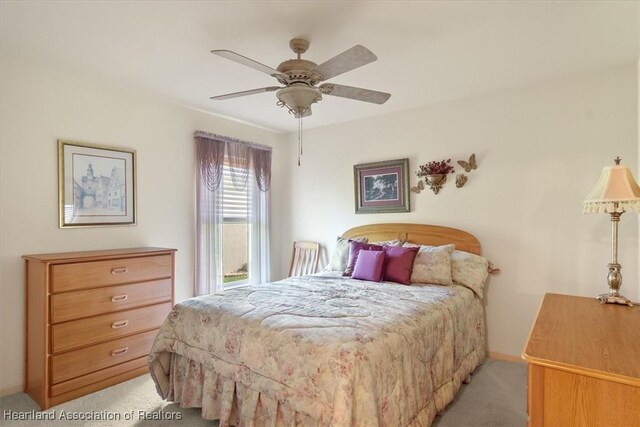 bedroom featuring light carpet and ceiling fan