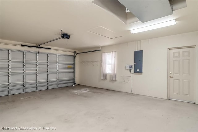 garage with a garage door opener and electric panel