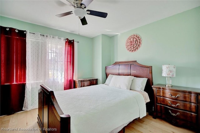 bedroom with ceiling fan and light hardwood / wood-style floors