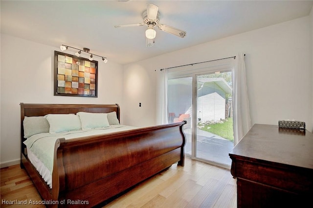 bedroom with access to exterior, light wood-type flooring, and ceiling fan