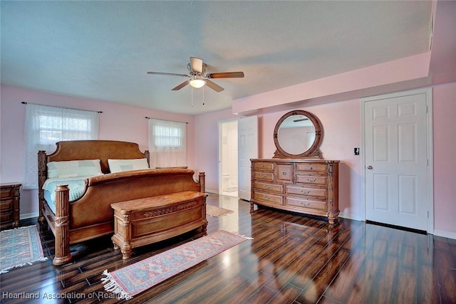 bedroom with dark hardwood / wood-style floors and ceiling fan