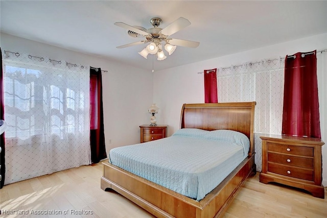 bedroom with hardwood / wood-style flooring and ceiling fan