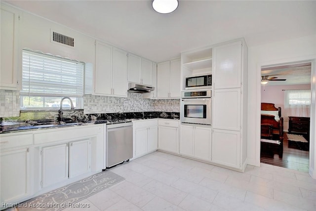 kitchen featuring stainless steel appliances, white cabinetry, ceiling fan, and sink