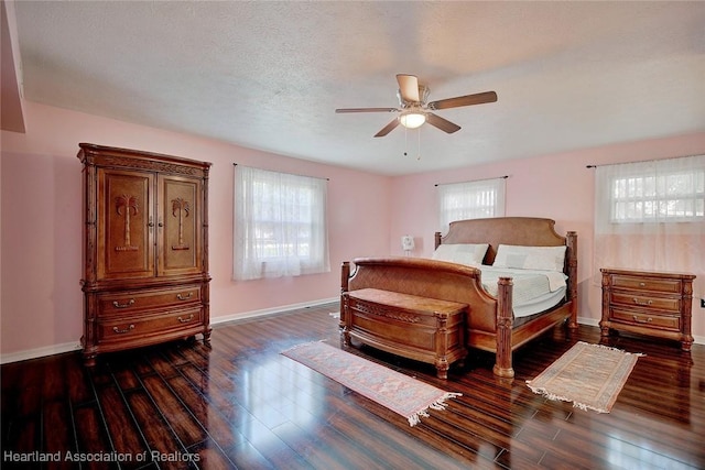 bedroom featuring a textured ceiling, ceiling fan, and dark hardwood / wood-style floors