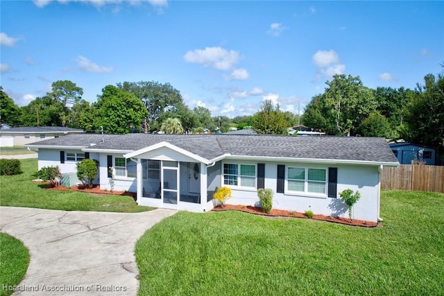 single story home with a front yard and a sunroom