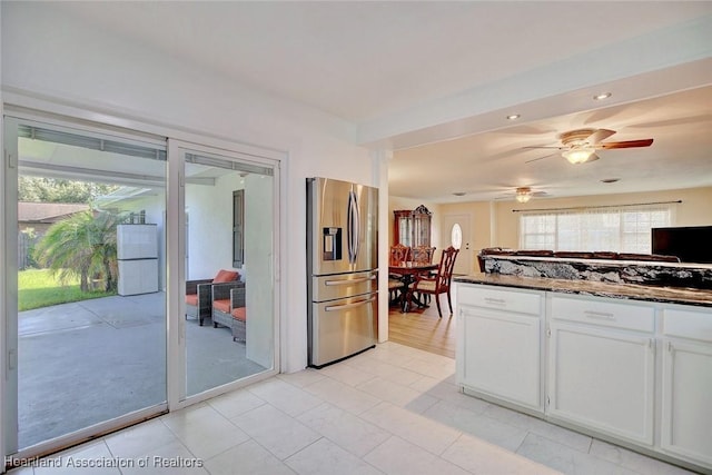 kitchen with white cabinetry, stainless steel fridge with ice dispenser, white fridge, and ceiling fan