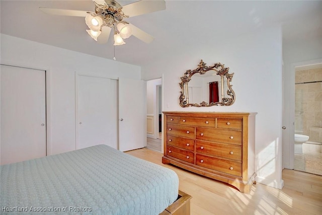 bedroom with ceiling fan, light hardwood / wood-style flooring, and ensuite bath