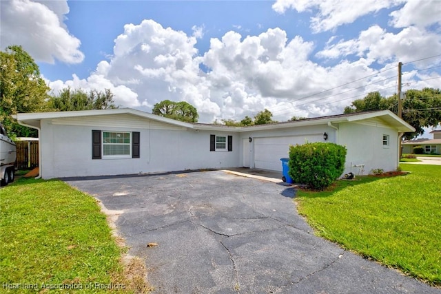 single story home with a front yard and a garage