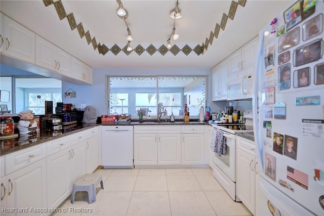 kitchen featuring white cabinetry, white appliances, sink, and light tile patterned floors