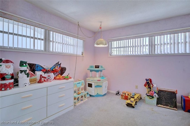 recreation room with carpet flooring