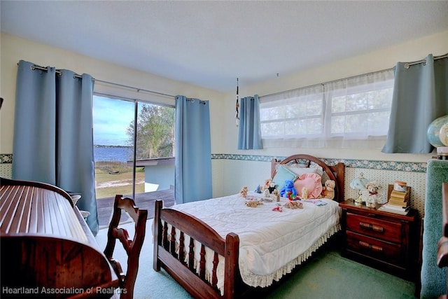 carpeted bedroom featuring a water view