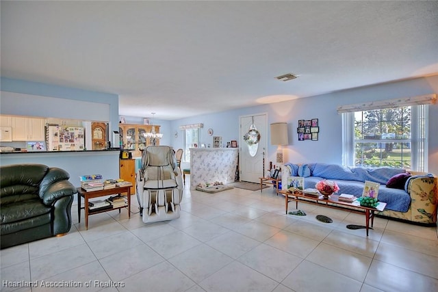 living room with an inviting chandelier and light tile patterned floors