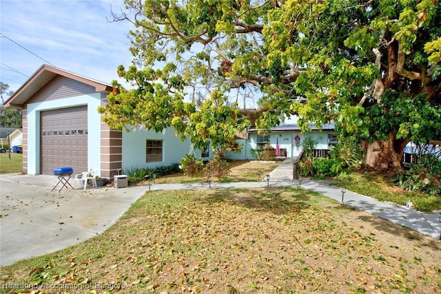 view of front facade with a garage and a front lawn