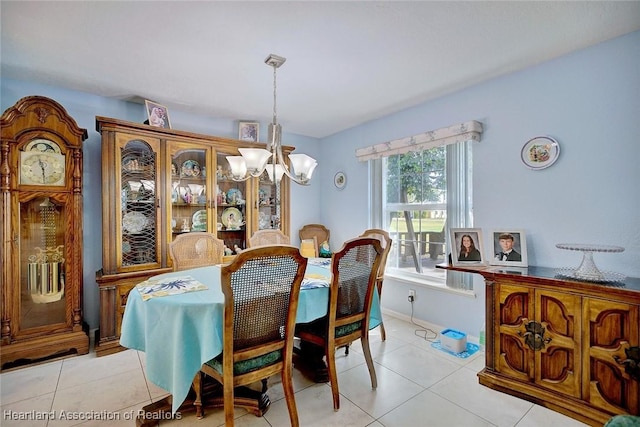 dining room with a chandelier and light tile patterned floors