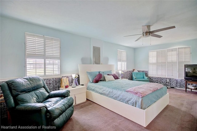 bedroom featuring ceiling fan and carpet