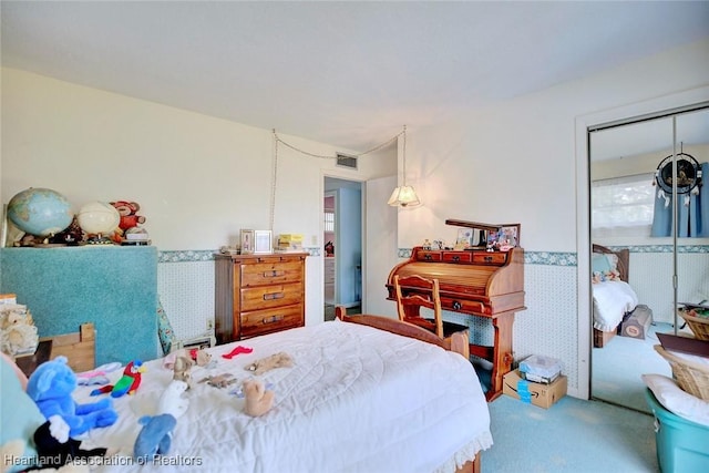 carpeted bedroom featuring a closet