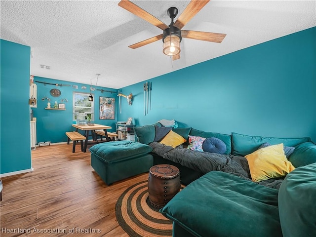 1802 W Fondulac Rd, Avon Park, FL 33825 - living area featuring wood finished floors, a ceiling fan, baseboards, and a textured ceiling