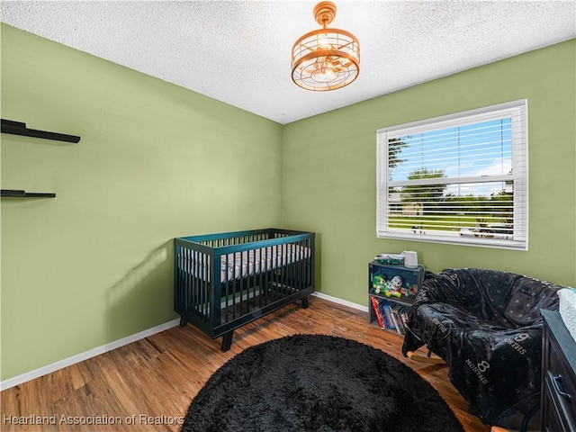 1802 W Fondulac Rd, Avon Park, FL 33825 - bedroom featuring baseboards, wood finished floors, and a textured ceiling