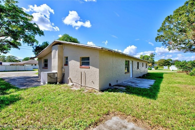 view of home's exterior with a lawn