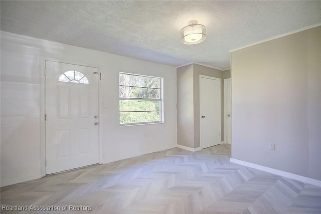 foyer featuring light parquet floors and a textured ceiling