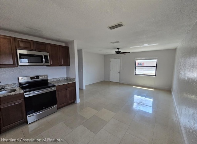 kitchen featuring dark brown cabinets, a textured ceiling, stainless steel appliances, and ceiling fan