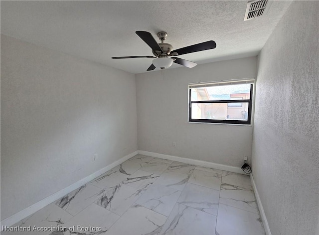 spare room with ceiling fan and a textured ceiling